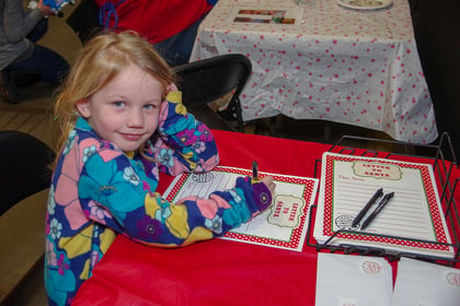 Young girl writing a letter to Santa