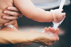 baby and adult washing hands