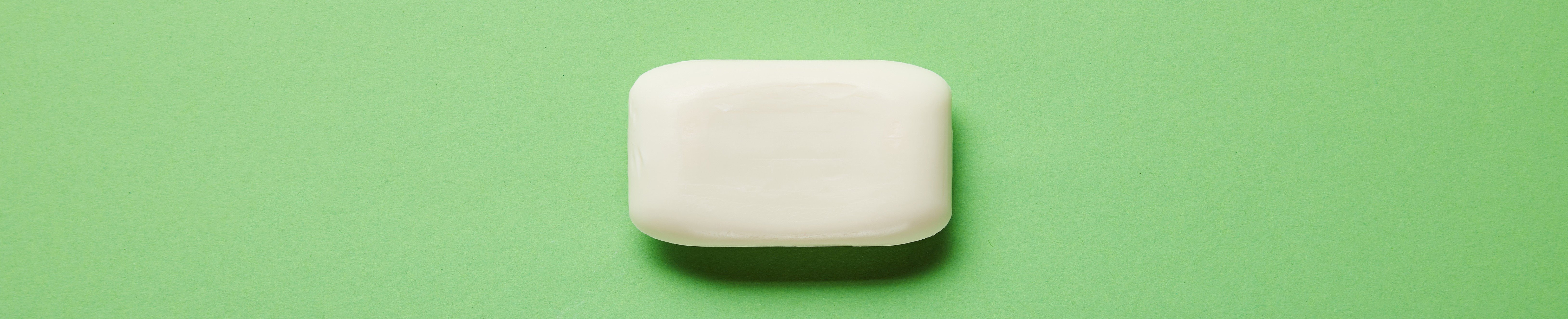 white bar soap on green background