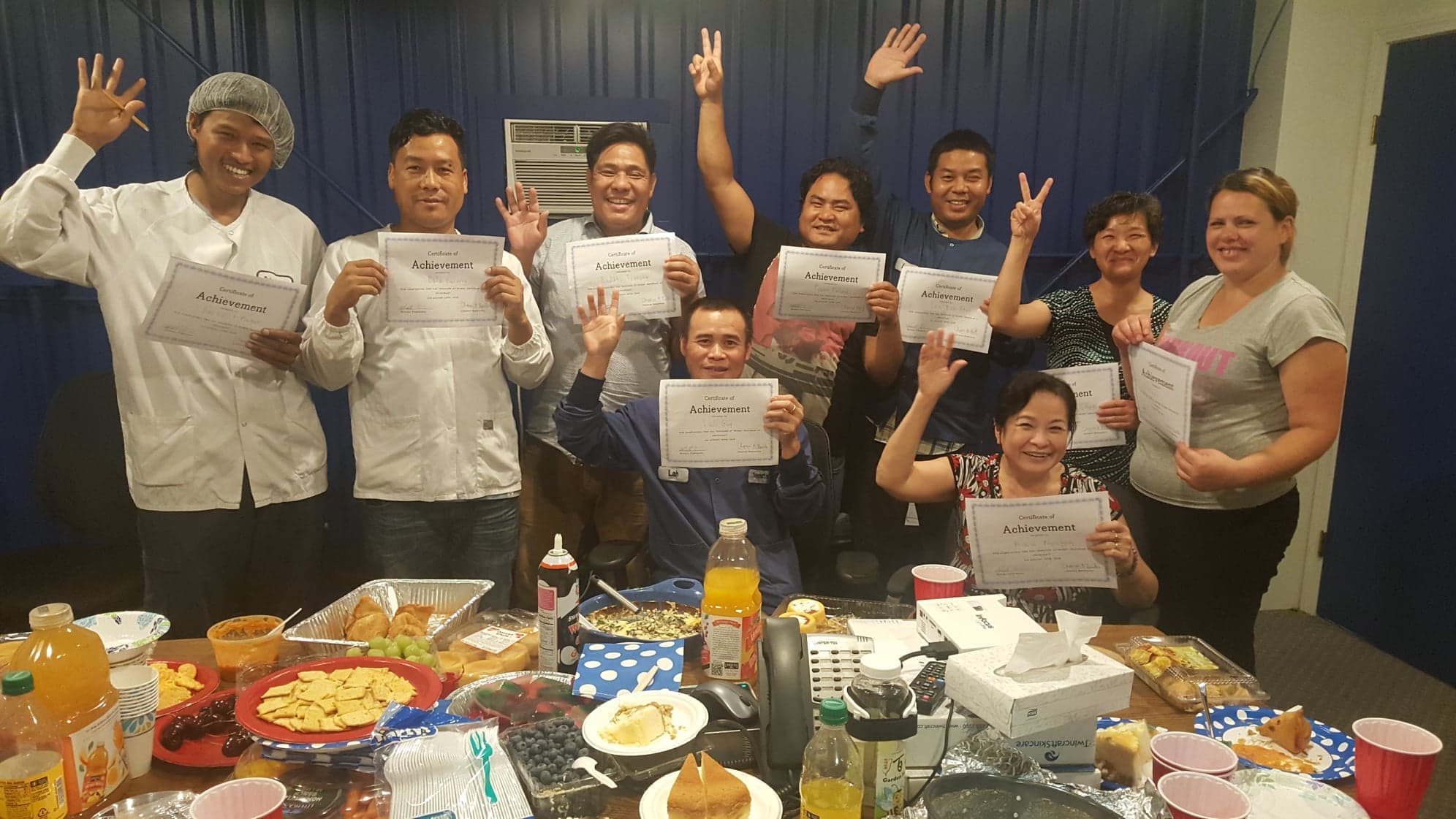 Twincraft New American employees with Certificates of Achievement for English as a Second Language Course