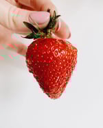 hand holding strawberry