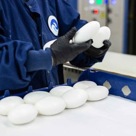 Twincraft Skincare employee inspecting bar soap in production