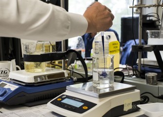 lab engineer stirring product in beaker