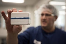 Twincraft employee holding bar soap
