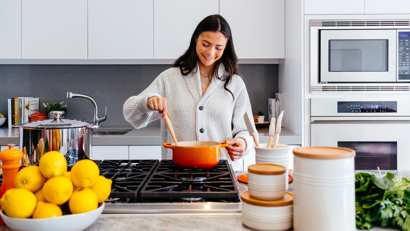 woman cooking on stove